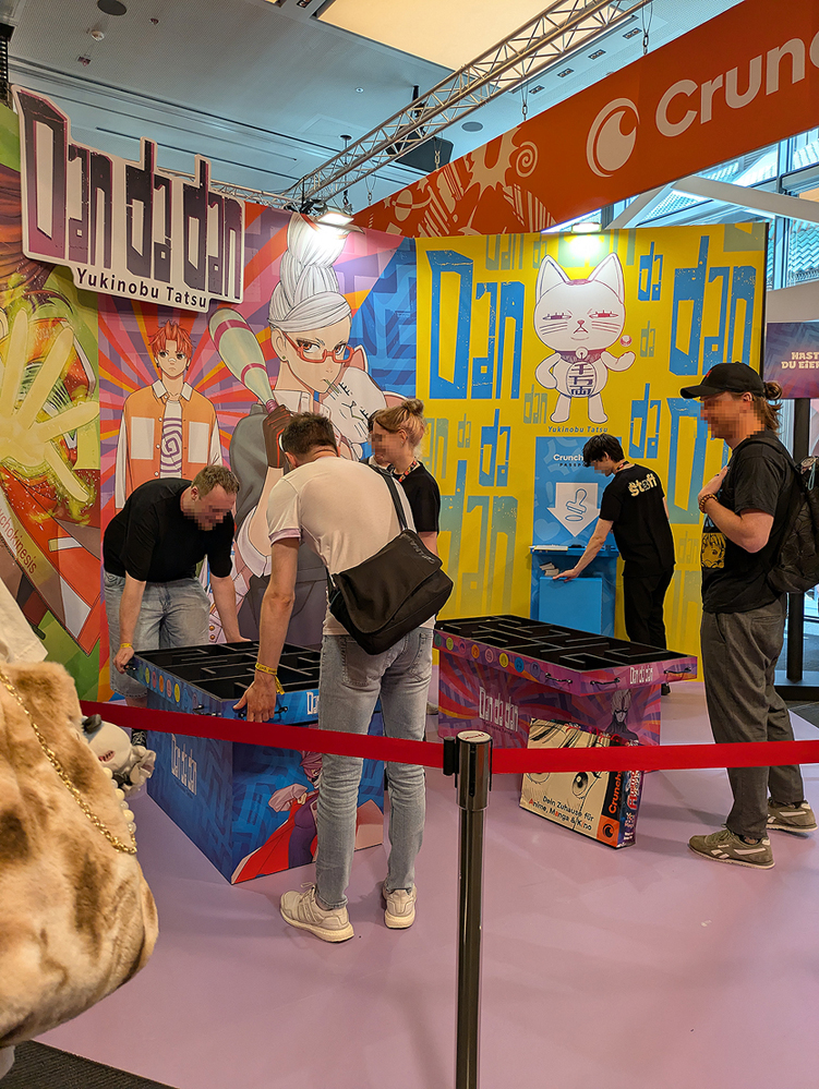 photo of the crunchy roll area at Animagic 2025: a dandadan themed booth were you could play games