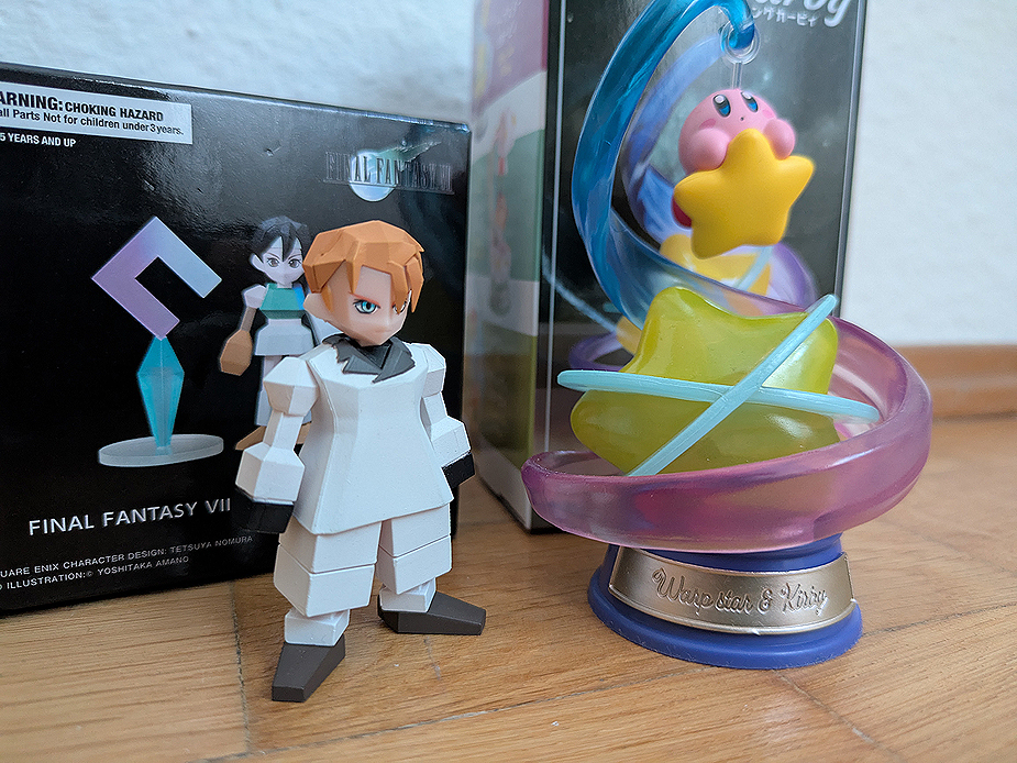 photo of two blind box figures: Final Fantasy VII polygon figure of Rufus Shinra and a Rement Swinging Kirby